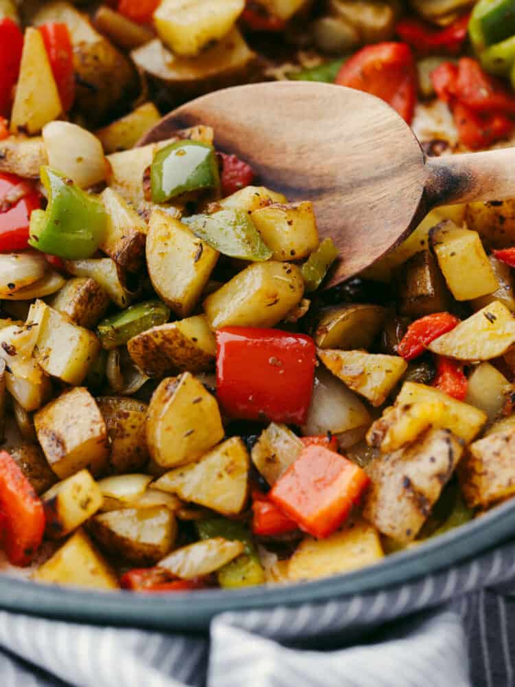 These breakfast potatoes make the best hearty and delicious breakfast! Filled with peppers, onions, and potatoes that are all coated with delicious homemade seasoning, this savory dish will become a family favorite! A close up of cooked breakfast potatoes.