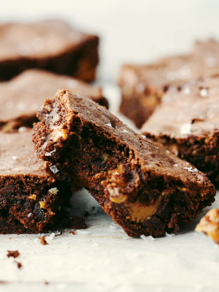 These salted caramel brownies are perfectly fudgy and moist brownies with an oozing salted caramel center. These will be one of the best brownies you sink your teeth into! A salted caramel brownie with a bite taken out of it.