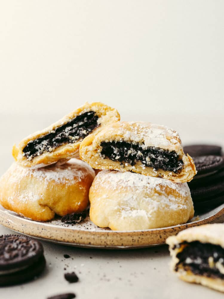 Get all the deliciousness of deep-fried Oreos without the mess or calories in this quick and easy air fryer Oreos recipe! It only takes 3 ingredients to make them and theyโll have the whole family hooked! A stack of 4 fried Oreos, 2 of which are split in half so the Oreo filling can be seen.