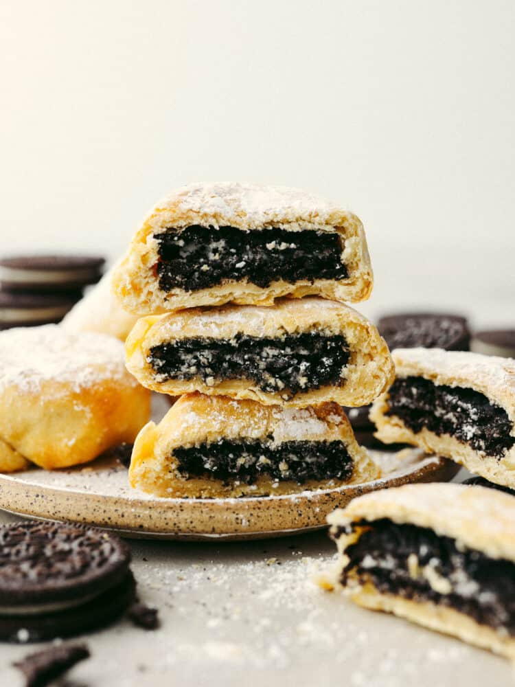 Get all the deliciousness of deep-fried Oreos without the mess or calories in this quick and easy air fryer Oreos recipe! It only takes 3 ingredients to make them and theyโll have the whole family hooked! 3 air fryer Oreos stacked on top of each other.