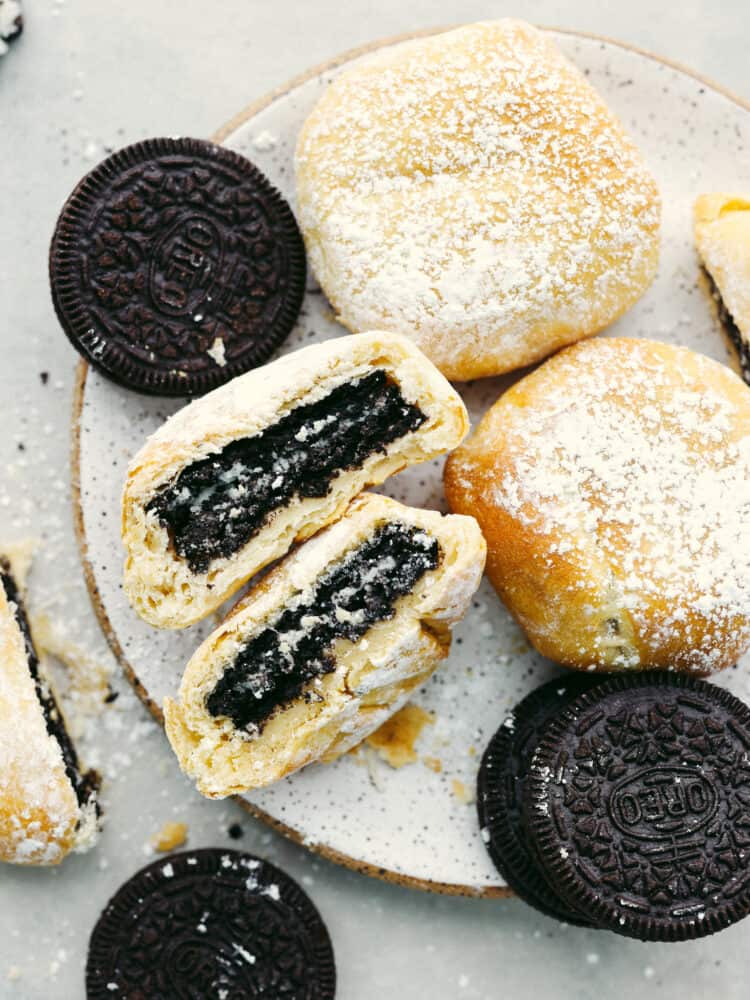 Get all the deliciousness of deep-fried Oreos without the mess or calories in this quick and easy air fryer Oreos recipe! It only takes 3 ingredients to make them and theyโll have the whole family hooked! Top-down view of fried Oreos on a stoneware plate.