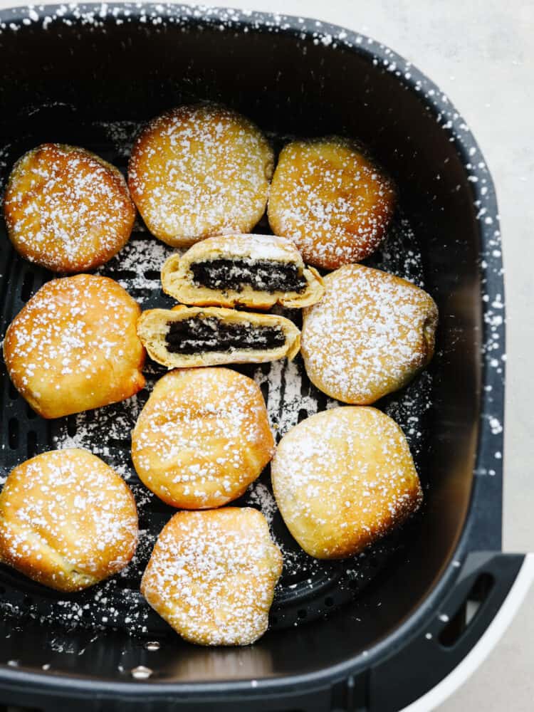Get all the deliciousness of deep-fried Oreos without the mess or calories in this quick and easy air fryer Oreos recipe! It only takes 3 ingredients to make them and theyโll have the whole family hooked! Multiple fried Oreos in the basket of an air fryer, dusted in powdered sugar.