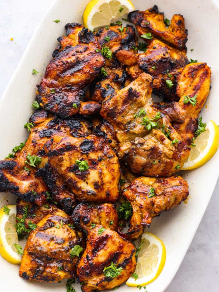 Shawarma seasoning brings aromatic and authentic Middle Eastern flavors to your recipes. This easy to assemble spice blend is great to make ahead and have on hand when you want to elevate your cooking flavors. Some grilled chicken on a platter that has been seasoned with shawarma seasoning.