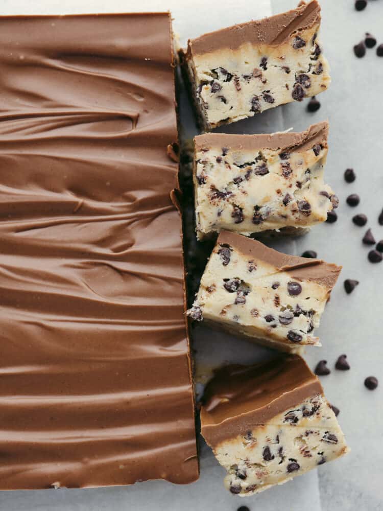 Get ready for these chocolate chip cookie dough bars to become a favorite you makeย all the time!ย Perfectly creamy and delicious (and with no raw egg), these bars will get devoured by anyone lucky enough to eat them! The top view of chocolate chip cookie dough bars.