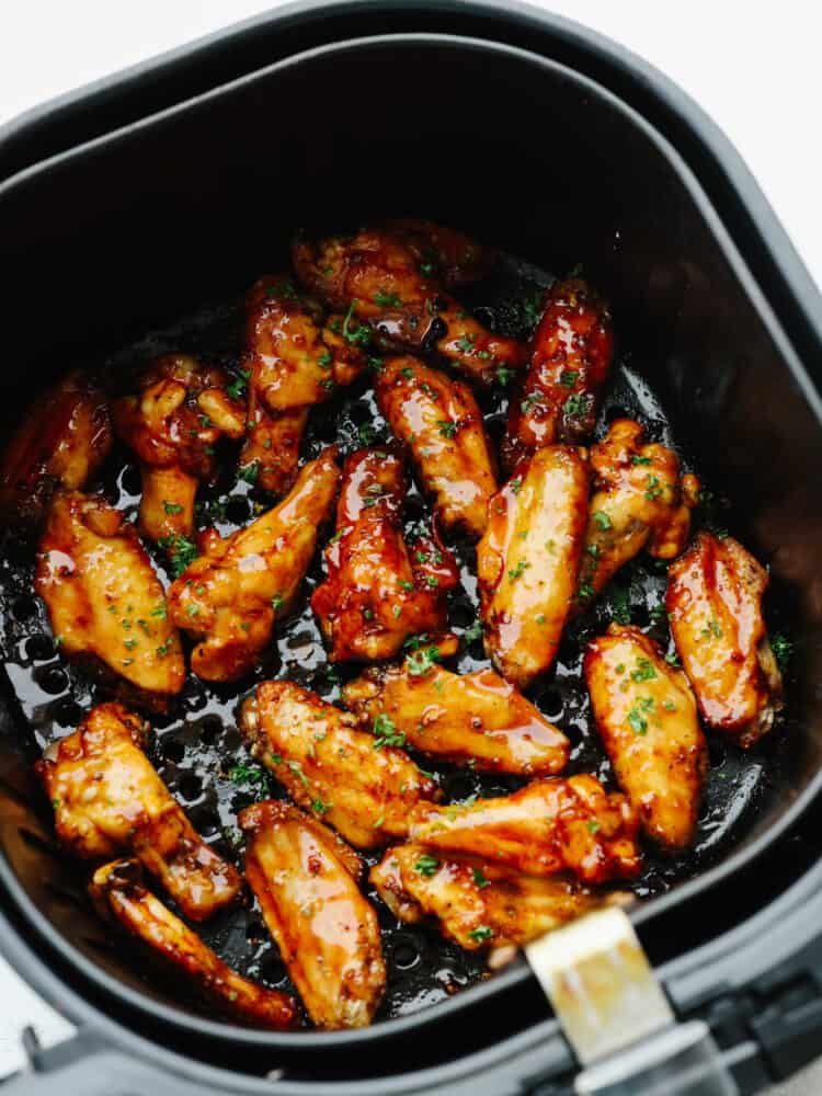 Making your frozen chicken wings in the air fryer is the only method to use, no thawing required! Along with this easy-to-make honey buffalo sauce, you'll never want them any other way! Cooked chicken wings in the basket of an air fryer, tossed in honey buffalo sauce.