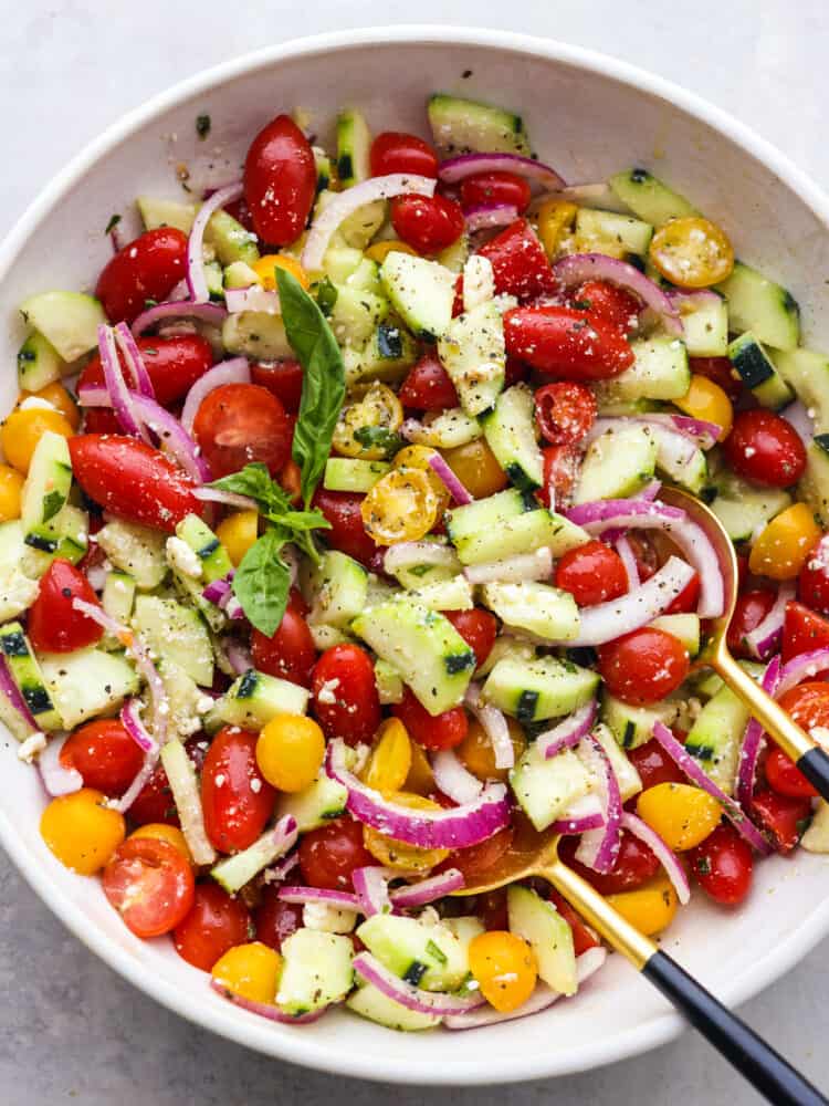 Chilled Cucumber Tomato Salad is a refreshing salad made with fresh ingredients that everyone can enjoy all year round. It's fast, easy, and can be made ahead, making it perfect for any potluck! The top view of a bowl of chilled cucumber tomatoe salad.