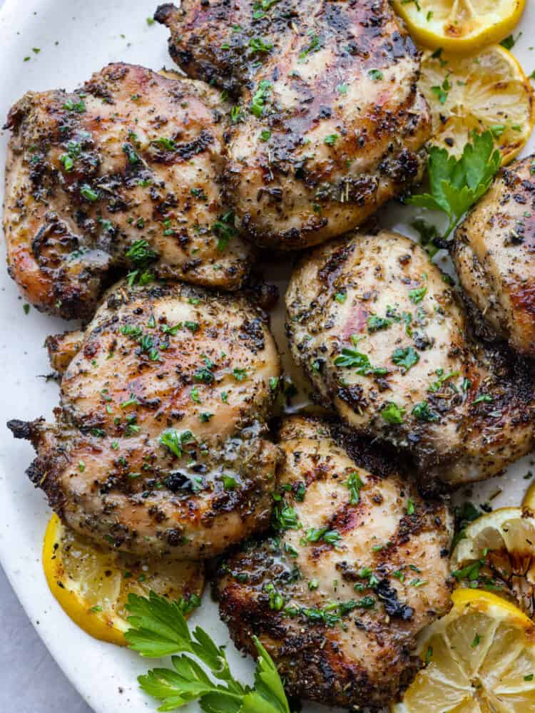 This easy grilled lemon chicken recipe just requires a few ingredients and grills up in just a few minutes! It's tender and juicy and packed with lots of fresh flavors! A close up of grilled lemon chicken.