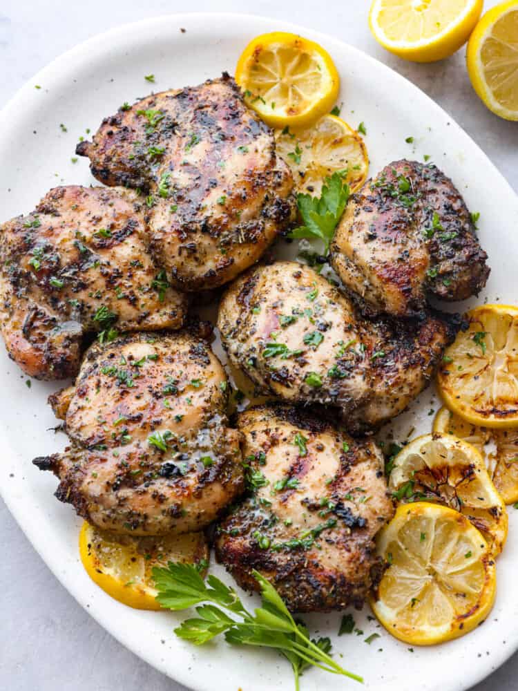 This easy grilled lemon chicken recipe just requires a few ingredients and grills up in just a few minutes! It's tender and juicy and packed with lots of fresh flavors! A platter of grilled lemon chicken, ready to serve.