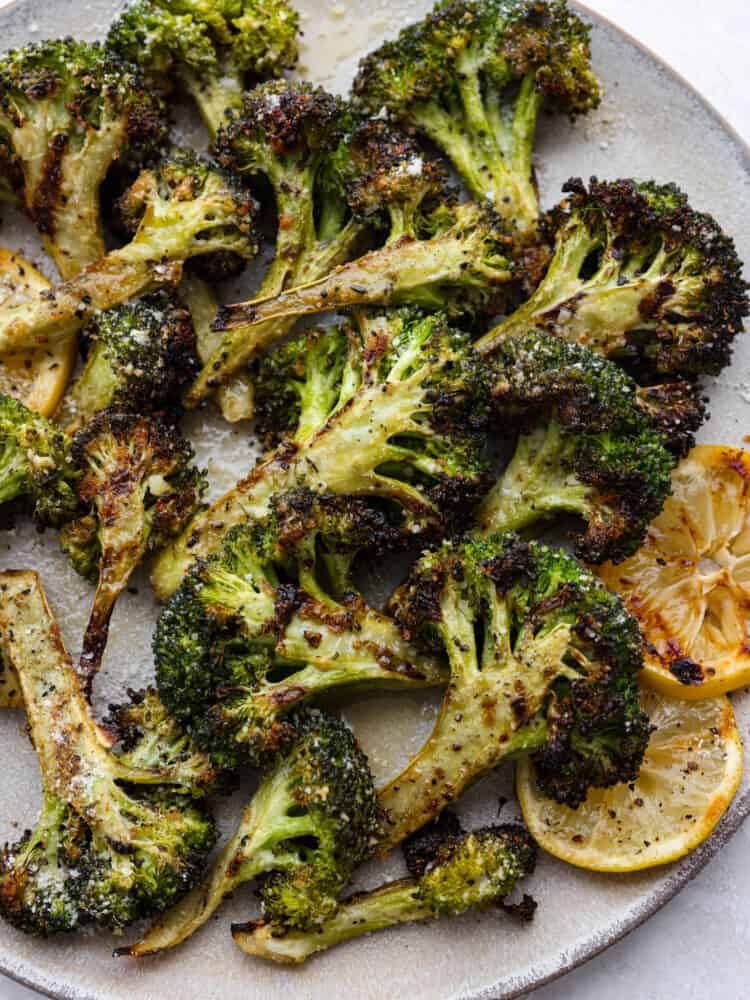 The perfect side dish for summer, parmesan garlic grilled broccoli is cooked to perfection and packed with so much flavor! It's the best addition to any barbecue. Closeup of parmesan garlic grilled broccoli.