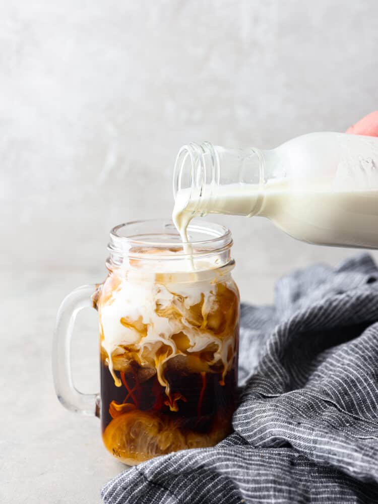 This homemade half and half is easy and it takes less than 5 minutes to make . Keep this recipe on hand, and you will never have to buy this at the store again! Half and half being poured into a glass cup filled with soda.