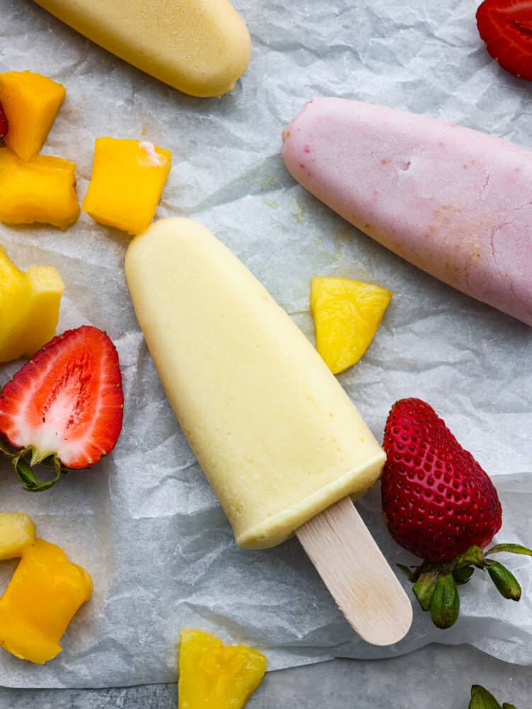 These fresh and fruity homemade popsicles will keep you cool all summer! They're naturally sweetened with honey and coconut milk for a refreshing, tasty treat. Closeup of a homemade popsicle.