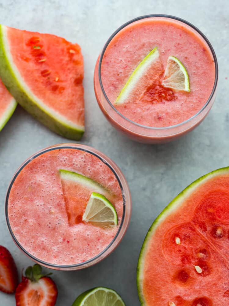 Find out what summer tastes like by drinking a sip of this watermelon smoothie! It's juicy, sweet, and made from the most delicious and flavorful fruit of the season... watermelon! The top view of glasses filled with watermelon smoothie.