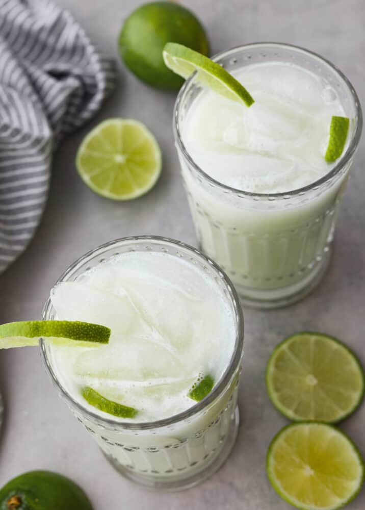 Brazilian lemonade is a 4-ingredient drink that is tangy, creamy, and refreshing! It’s the perfect mix of tart and sweet and will have your family hooked after first sip. Top-down view of 2 glasses of Brazilian lemonade.