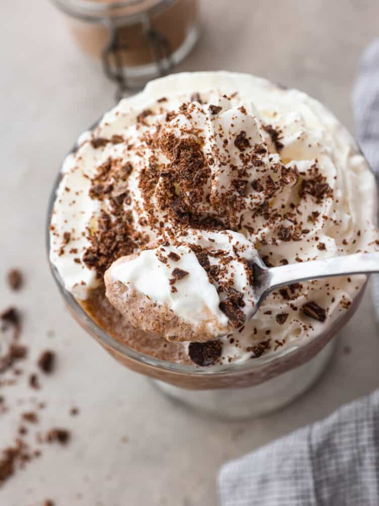 Craving hot chocolate in the summer? Now you can stay cool and satisfy your sweet tooth with a cup of this delicious frozen hot chocolate. It only takes a few simple ingredients to make and is ready in less than 5 minutes! Top-down view of frozen hot chocolate being eaten with a spoon.