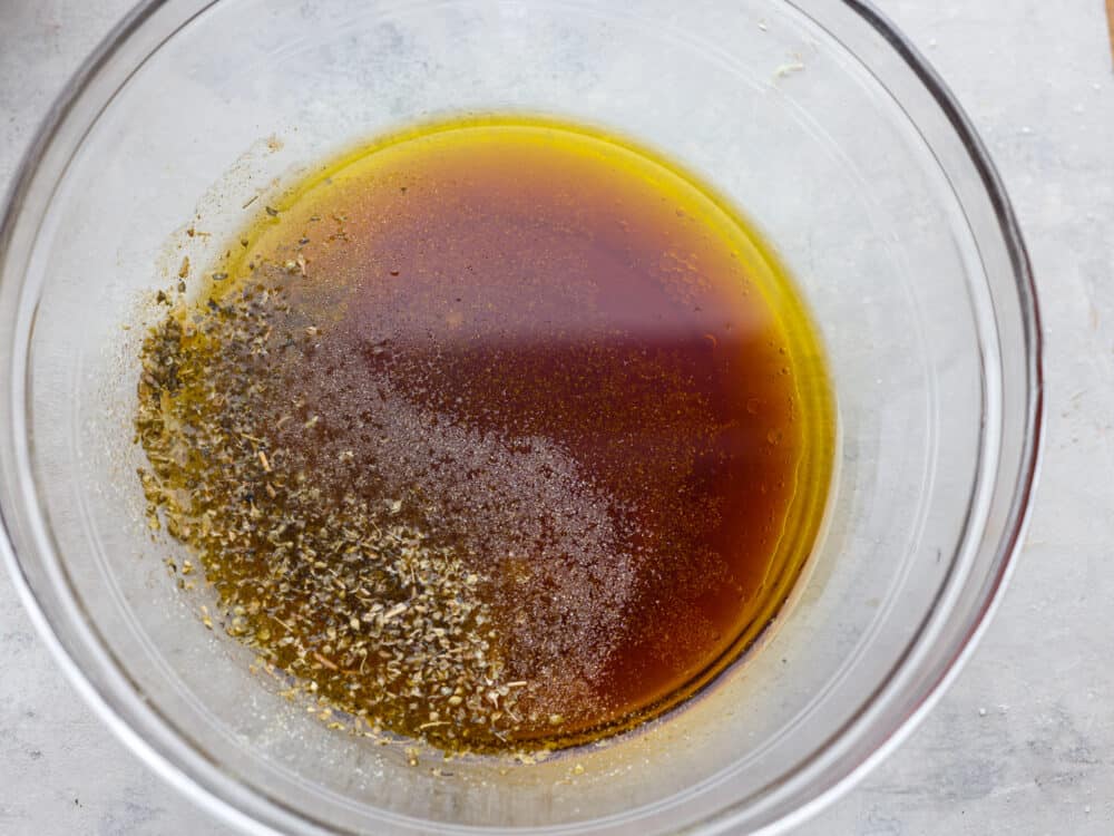 This homemade Italian dressing is the most delicious mixture of classic seasonings that will elevate any salad that you put it on. It has deep, complementing flavors that will leave your taste buds wanting more! Ingredients in a glass bowl, ready to be mixed.