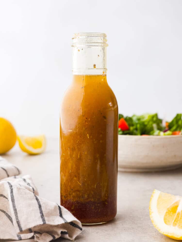 This homemade Italian dressing is the most delicious mixture of classic seasonings that will elevate any salad that you put it on. It has deep, complementing flavors that will leave your taste buds wanting more! A glass bottle of Italian Salad Dressing.