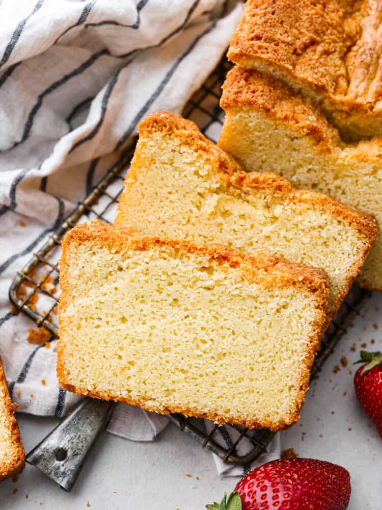 This is a classic recipe that really IS the perfect pound cake! There is something about this exact mix of these simple pantry staple ingredients that results in a velvety smooth and perfectly dense and tender cake. Pound cake sliced up and laid out on a wire rack.