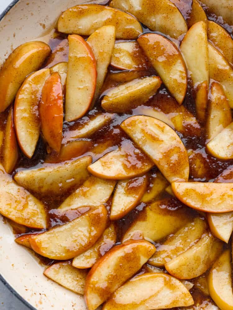 These apples are sautéed in a brown sugar and cinnamon mixture, making them insanely delicious! It's a match made in heaven when you top them with some vanilla ice cream or whipped cream! A close up of sautéed apples.