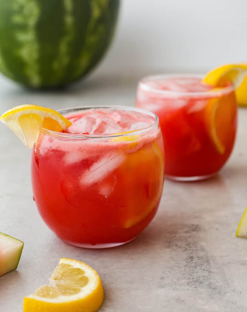 Juicy, sweet, and just a little bit sour, this sparkling watermelon lemonade is the most refreshing summer drink. Serve it at your next get-together and I promise it will be a huge hit! 2 glass cups filled with watermelon lemonade.