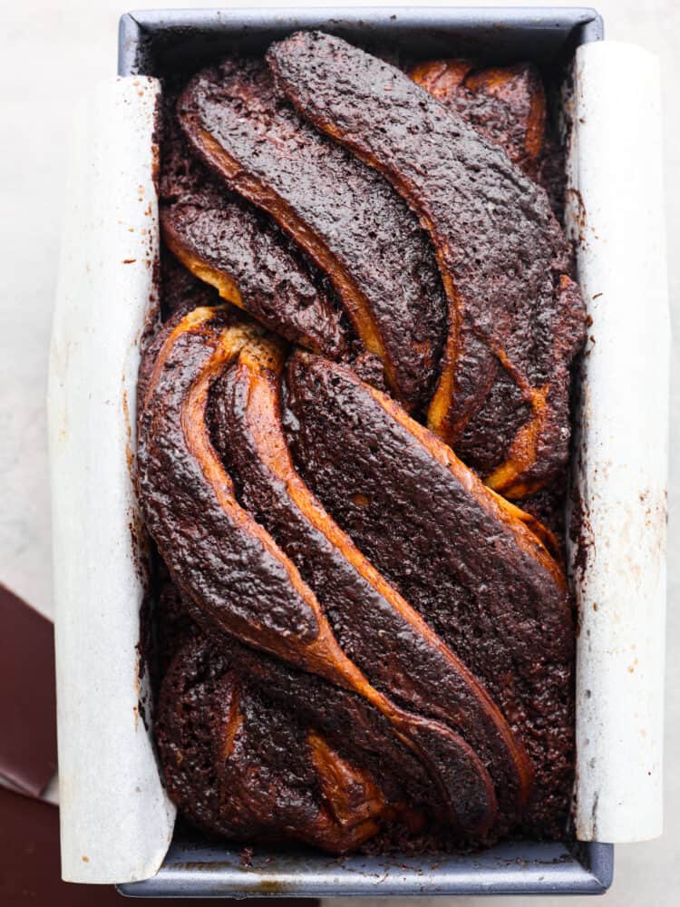 Youโre not going to be able to get enough of this soft, sweet babka bread filled with luscious chocolate! With its beautiful swirled interior, it looks as good as it tastes! Top-down view of a whole loaf of babka bread.