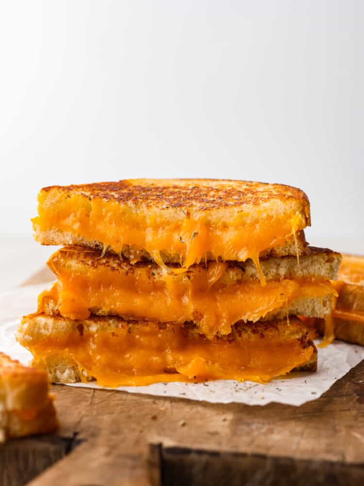 You will never cook another grilled cheese sandwich again after you try this one! It's deliciously cheesy on the inside, and once you sink your teeth into that crispy outside, it is absolute perfection! A stack of slices of grilled cheese sandwich.