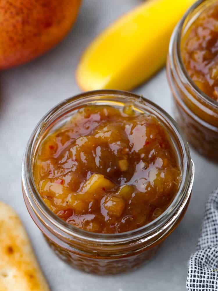 This delightful mango chutney is a spread that can be used in so many different recipes! It packs a punch when it comes to flavor, and you will always want to have some on hand! The topview of a glass jar filled with tomato chutney.