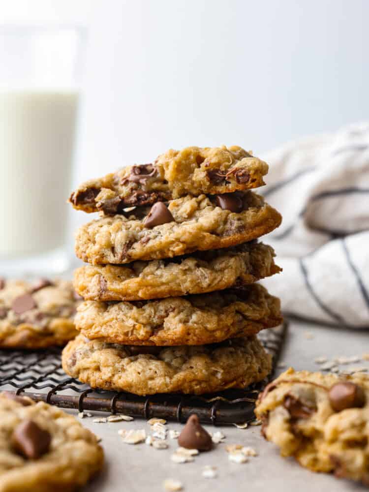 These oatmeal chocolate chip cookies are crispy on the outside, chewy on the inside, and loaded with chocolate! They are insanely delicious, and the flavors combine to make the best cookie of all time! A stack of oatmeal chocolate chip cookies.