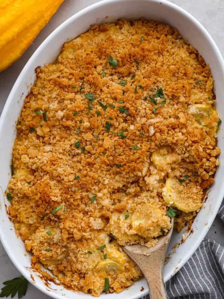 This recipe is the best way to use up that yellow summer squash!ย Squash casserole is a great way to use up fresh squash from your garden. Easy to make with a creamy, cheesy filling and a crispy, buttery topping! A casserole dish wil cooked squash casserole.