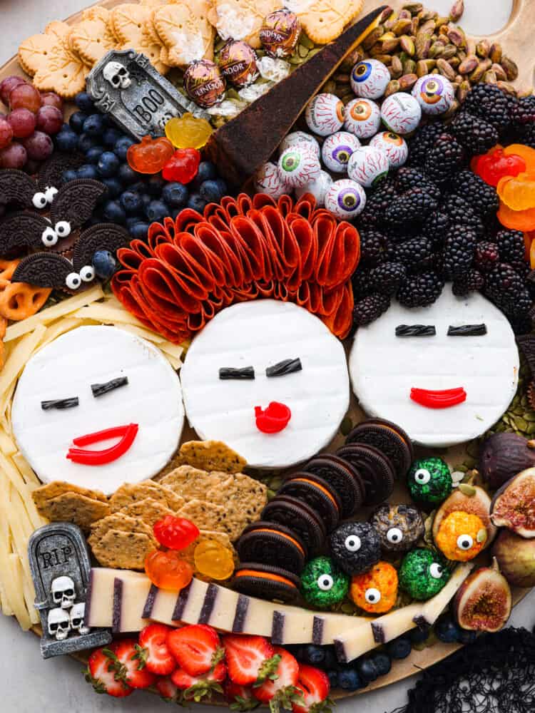 A tribute to the Sanderson Sisters, this Hocus Pocus charcuterie board will have all of your guests dying at not only the delicious variety of food but the uncanny resemblance to some of Halloween's most famous witches! A close up picture of the Hocus Pocus charcuterie board.