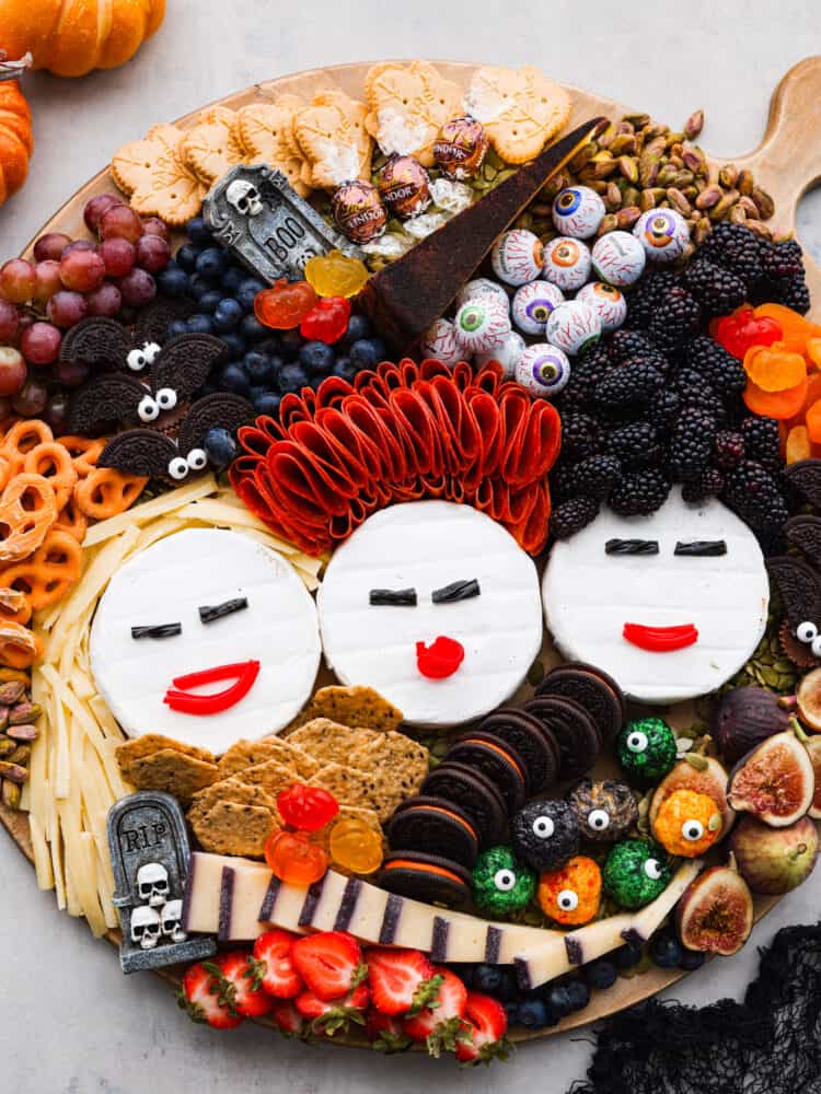 A tribute to the Sanderson Sisters, this Hocus Pocus charcuterie board will have all of your guests dying at not only the delicious variety of food but the uncanny resemblance to some of Halloween's most famous witches! The top view of a Hocus Pocus Charcuterie Board.