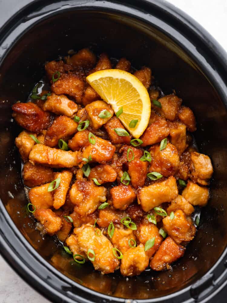 This delicious and tangy orange chicken is made right in your slow cooker! This is better than takeout! This tender chicken is coated in a irresistible sauce that will keep your family asking for this at least once a week! Cooked orange chicken in the crockpot.