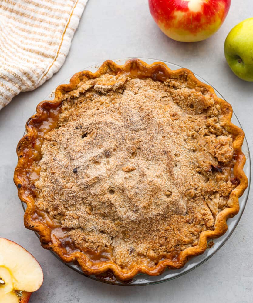 Dutch Apple Pie is the best version of apple pie! Instead of a top crust, you enjoy a sweet crumble topping over a mound of delicious apples. Everyone will agree that this is the best apple pie they've ever had. Top-down view of a whole Dutch apple pie.