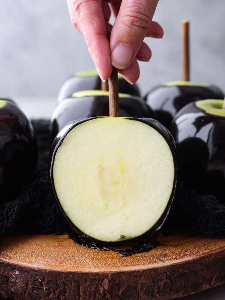 Poison caramel apples are the perfect haunted Halloween treat! The glossy black color not only looks spooky but it tastes absolutely amazing! It's definitely a dessert that will be sure to impress your guests!