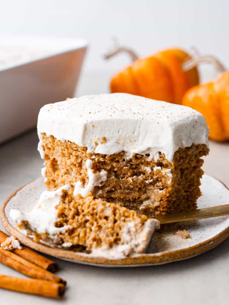 If youโre a fan of traditional tres leches, youโre going to absolutely LOVE this fall version! Soft, moist, and loaded with spiced pumpkin flavor, this pumpkin tres leches is the perfect dessert switch-up for the holidays! A slice of pumpkin tres leches with a bite taken out of it.
