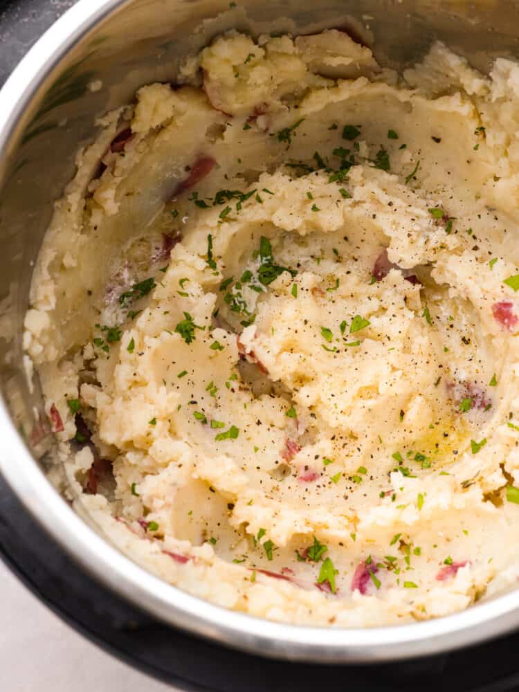 These Instant Pot mashed potatoes are an easy side dish for any holiday or weeknight dinner! They are creamy and flavorful and come together in just 15 minutes. Closeup of Instant Pot mashed potatoes.