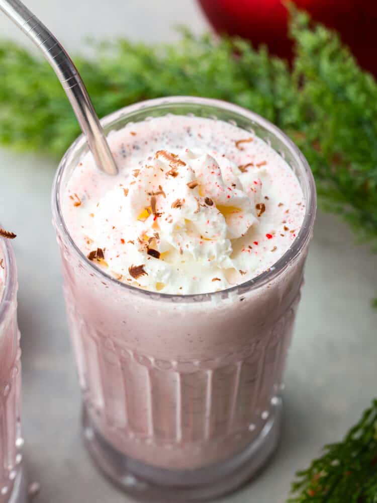 Chick-fil-A peppermint milkshakes are one of the best things about the holiday season, but they're always gone too soon! Here's how you can make this delicious peppermint shake at home with just a few simple ingredients. A peppermint milkshake in a glass cup.