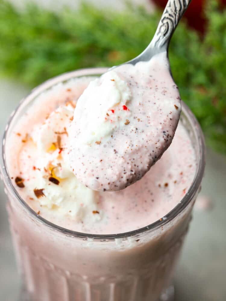 Chick-fil-A peppermint milkshakes are one of the best things about the holiday season, but they're always gone too soon! Here's how you can make this delicious peppermint shake at home with just a few simple ingredients. Closeup of a peppermint milkshake with a spoon scooping some out.