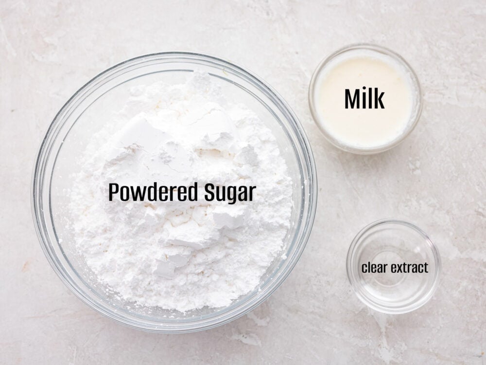 Sweet and silky Powdered Sugar Glaze is the perfect topping for your baked goods and desserts. It is so simple to make with just 3 ingredients and will be the perfect addition to your goodies! Ingredients to make the glaze in glass bowls.