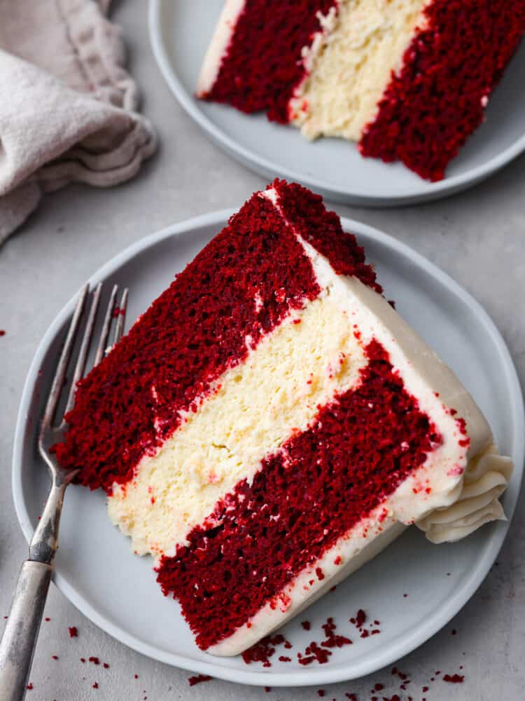 Can’t decide between red velvet cake and cheesecake? Why not both! This dreamy dessert is made with layers of moist red velvet cake and rich cheesecake topped with a luscious cream cheese frosting. Top-down view of a slice of red velvet cheesecake.