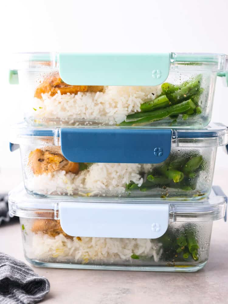 If you’re looking to save time, keep your sanity, and hit your protein goals, these chicken and rice meal prep bowls have you covered. They're flavorful, filling, and give you that “I’ve got my life together” feeling. 3 airtight containers filled with chicken and rice stacked on top of each other.
