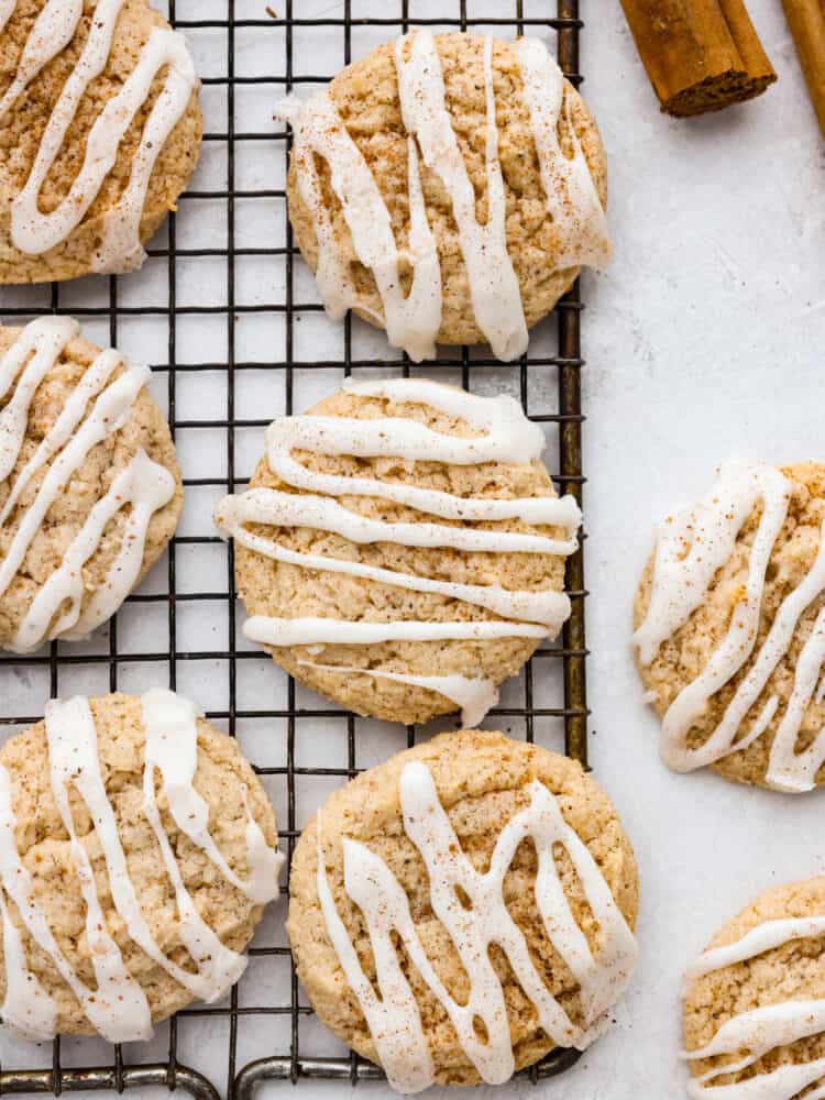 These eggnog cookies are soft, chewy, and beautifully flavored with hints of cinnamon and nutmeg. They are going to become fast favorites with their heavenly eggnog glaze! Top-down view of cookies on a cooling rack.