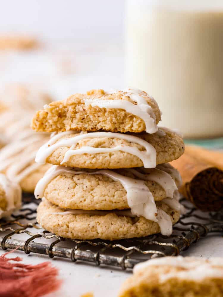 These eggnog cookies are soft, chewy, and beautifully flavored with hints of cinnamon and nutmeg. They are going to become fast favorites with their heavenly eggnog glaze! A stack of 4 eggnog cookies stacked on top of each other.
