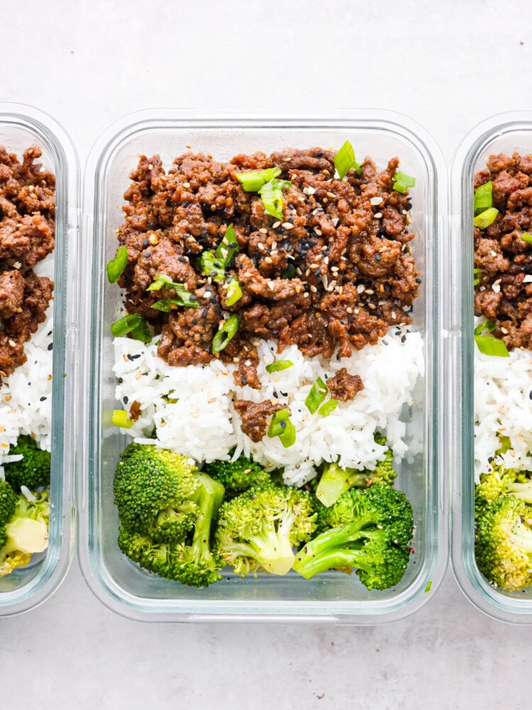 Ready to spice up your meal prep game? Look no further than these delicious Korean beef meal prep bowls! Perfect for busy moms on the go, these bowls are packed to the brim with flavor and nutrition. Top-down view of Korean beef served with rice and broccoli in plastic containers.