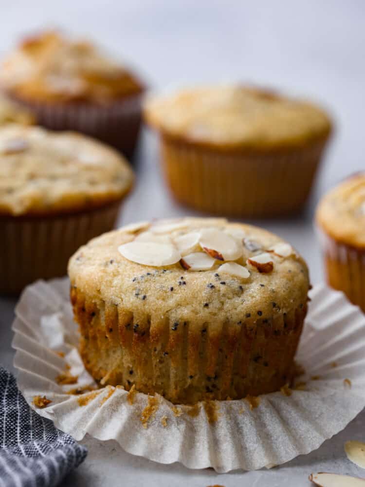 With a moist and fluffy texture, these almond poppy seed muffins are sure to satisfy your taste buds and keep you feeling full and energized all morning long. Theyโre the perfect grab-and-go breakfast! An almond poppy seed muffin with the cupcake liner unwrapped.