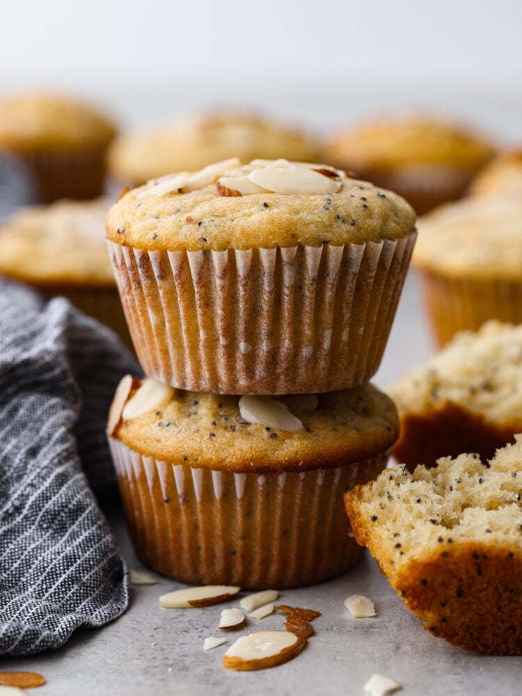 With a moist and fluffy texture, these almond poppy seed muffins are sure to satisfy your taste buds and keep you feeling full and energized all morning long. Theyโre the perfect grab-and-go breakfast! 2 muffins stacked on top of each other.