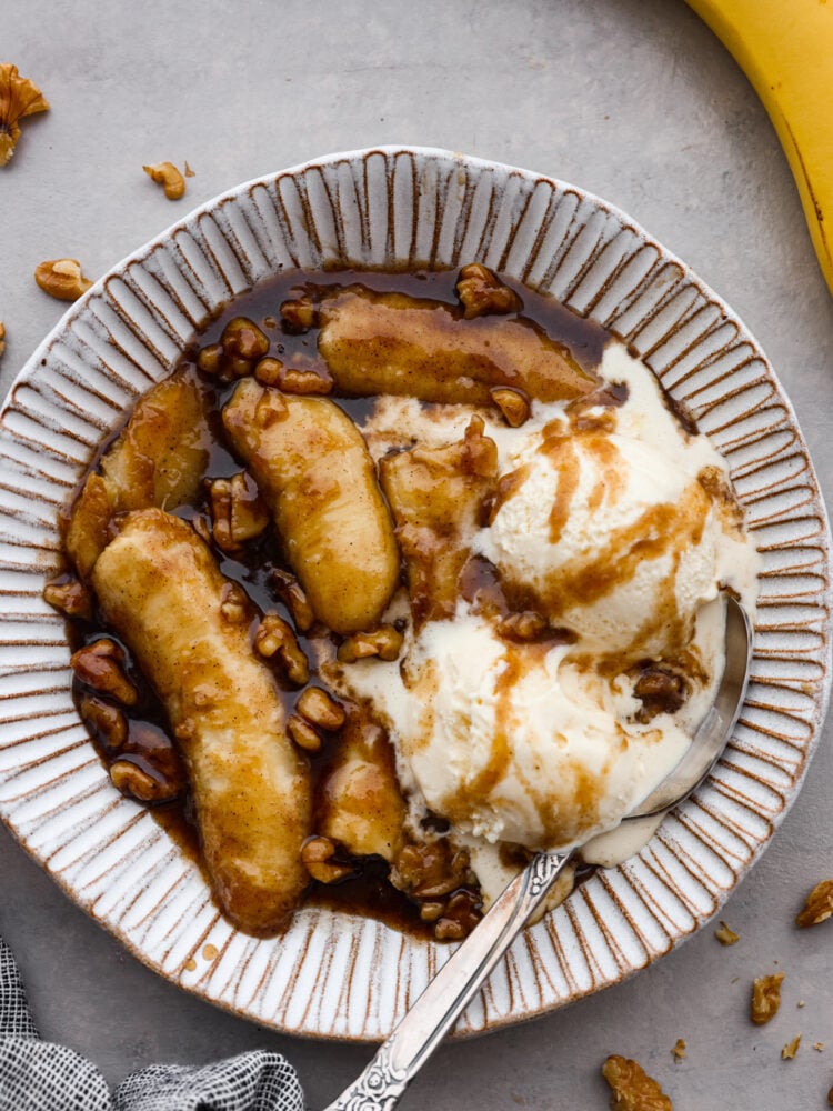 Warm, soft bananas covered in a buttery, cinnamon rum sauce and served with vanilla ice cream. What could be better than that? Bananas foster is a classic dessert that's ready in 15 minutes and sure to impress. Bananas foster served with ice cream in a white stoneware bowl.