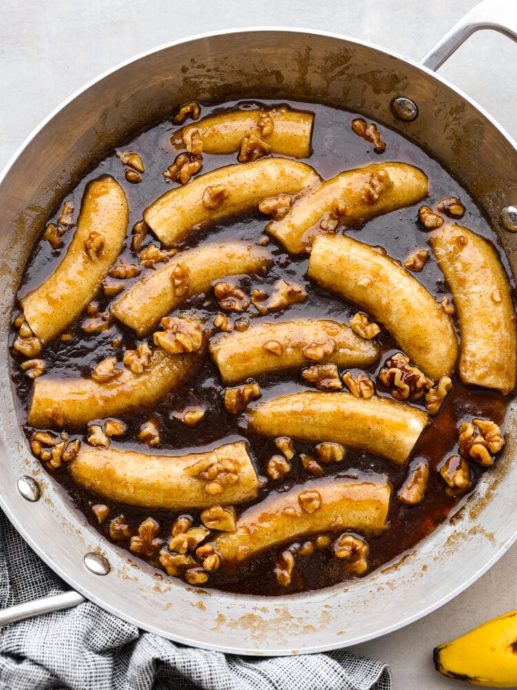 Warm, soft bananas covered in a buttery, cinnamon rum sauce and served with vanilla ice cream. What could be better than that? Bananas foster is a classic dessert that's ready in 15 minutes and sure to impress. Top-down view of bananas foster in a metal skillet.