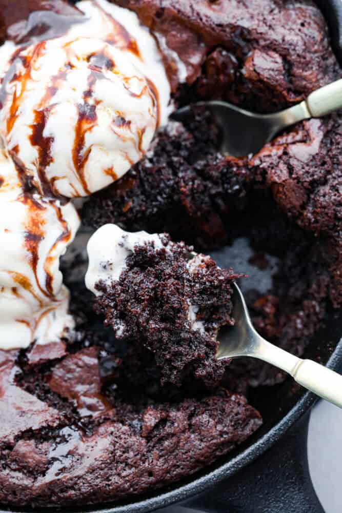 This easy skillet brownie is just the chocolatey, ooey-gooey dessert you need in your life! Top it off with a scoop of vanilla ice cream for the ultimate indulgent treat you can enjoy straight from the pan! Closeup of a skillet brownie.