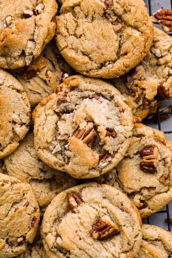 Soft, chewy,ย butter pecan cookiesย made with lightly toasted pecans andย crunchy toffee bits. These are buttery and delicious and there's no mixer or chilling required! Closeup of cookies.