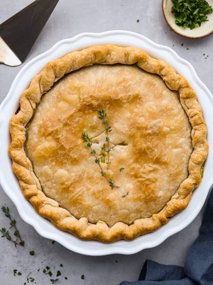 There is nothing more comforting than this absolutely perfect chicken pot pie! A flaky pie crust filled with chicken, veggies, and tons of flavor is just what you need on a cold winter day, or any day. This is a classic recipe you will definitely want in your recipe book! An overhead view of a whole absolutely perfect chicken pot pie.